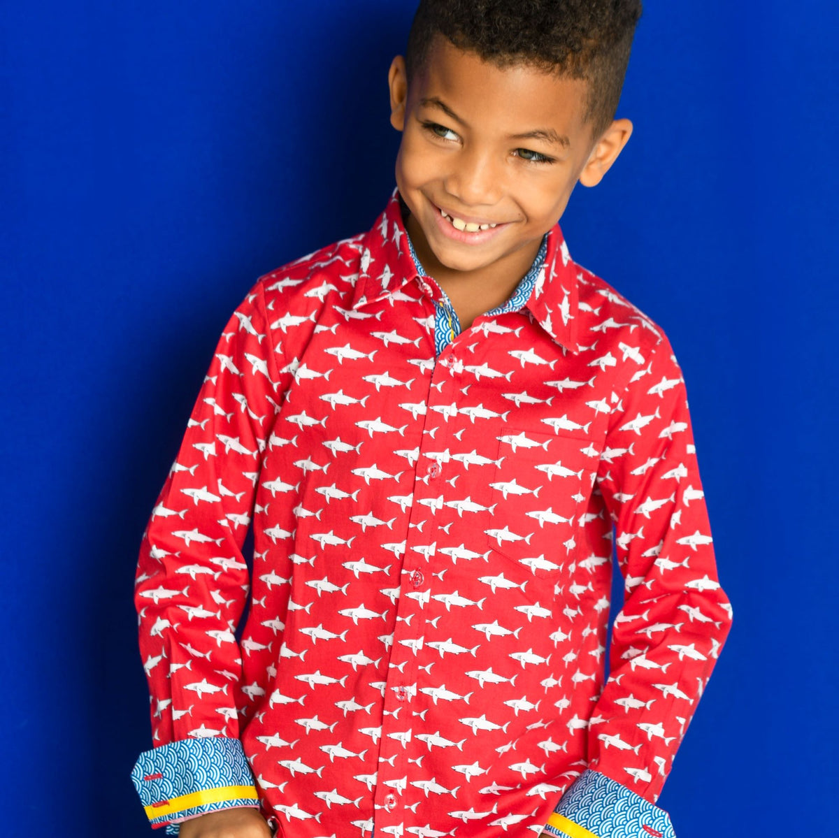 TukTuk Designs Boys shirts in a fun red mako shark print, designed to spark the imagination of little minds. Thoughtfully tailored in small batches and with fine detailing for stylish little gentlemen. Perfect for beach vacations, holidays, parties and memorable moments for the shark-obsessed! Available in matching girls dress.