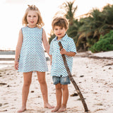 TukTuk Designs girls nautical origami sailboat shift dress with blue and green delicate sailboats, blue trim and side pockets. Available matching boys, sibling shirt .