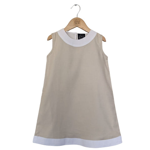 TukTuk Designs girls classic shift dress in sandy beige with white trims and side pockets. Perfect for the beach, play dates and everyday.