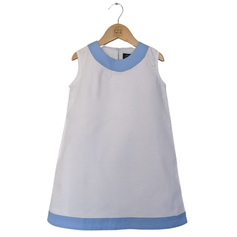 TukTuk Designs girls classic shift dress in cool white with blue trims and side pockets. Perfect for the beach, play dates and everyday.